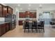 Modern kitchen featuring dark cabinets, stainless steel appliances, and an island with bar seating at 5021 Sw 88Th St, Ocala, FL 34476