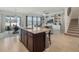 Open kitchen features a large island with bar seating and stainless steel appliances at 5021 Sw 88Th St, Ocala, FL 34476