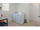 A practical laundry room with a washer, dryer, and a window for natural light, making laundry tasks a breeze at 5021 Sw 88Th St, Ocala, FL 34476