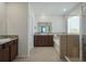 A luxurious main bathroom with a double vanity, soaking tub, and a glass-enclosed shower, providing a spa-like experience at 5021 Sw 88Th St, Ocala, FL 34476