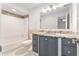 This renovated bathroom features a tub shower, granite vanity, and tile floors at 5041 Ne 4Th St, Ocala, FL 34470