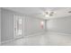 An airy bedroom with a ceiling fan, light-grey walls, and white-tile floors at 5041 Ne 4Th St, Ocala, FL 34470