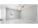 This bedroom features a ceiling fan, marble tile floors, neutral paint, and a window to bring in natural light at 5041 Ne 4Th St, Ocala, FL 34470