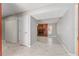 Hallway leading to the living room with tile flooring and view of the brick fireplace at 5041 Ne 4Th St, Ocala, FL 34470