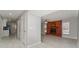 Hallway leading to the living room with tile flooring and view of the brick fireplace at 5041 Ne 4Th St, Ocala, FL 34470