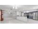 Open-concept kitchen with marble countertops, stainless steel appliances, and tile flooring throughout the living area at 5041 Ne 4Th St, Ocala, FL 34470