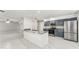 Modern kitchen with granite countertops, stainless steel appliances, and open floorplan leading to living area at 5041 Ne 4Th St, Ocala, FL 34470