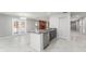 Open kitchen featuring a large island, tile floors, stainless steel appliances, and open access to the living area at 5041 Ne 4Th St, Ocala, FL 34470