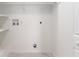 This laundry room features shelving for storage, washer and dryer hookups, and easy-to-clean floors at 5041 Ne 4Th St, Ocala, FL 34470