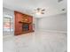 Living room featuring tile flooring, brick fireplace, and windows overlooking the backyard pool at 5041 Ne 4Th St, Ocala, FL 34470