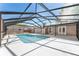 Enclosed pool with pool deck, screened enclosure, ladders, and access to house at 5041 Ne 4Th St, Ocala, FL 34470