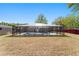 The caged pool offers outdoor fun with attractive landscaping and fencing for privacy and security at 5041 Ne 4Th St, Ocala, FL 34470