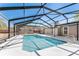Enclosed pool with pool deck, screened enclosure, ladders, and access to house at 5041 Ne 4Th St, Ocala, FL 34470