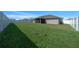 Large, well-maintained backyard, surrounded by a white fence with a view of the house at 5086 Sw 91St St, Ocala, FL 34476