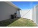 Side yard view showcasing the white fence, access gate, and water filtration system at 5086 Sw 91St St, Ocala, FL 34476