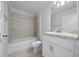 Bathroom featuring a tub/shower combo, toilet, and vanity with a decorative countertop at 5086 Sw 91St St, Ocala, FL 34476