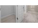 Bathroom entrance with a view of the glass shower and neutral tile flooring at 5086 Sw 91St St, Ocala, FL 34476