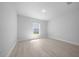Spacious bedroom with light wood floors, and window offering natural lighting at 5086 Sw 91St St, Ocala, FL 34476