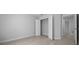 Spacious room showcasing the closet with doors and neutral walls and flooring at 5086 Sw 91St St, Ocala, FL 34476
