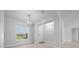 Open-concept entryway with natural light, wood-look tile flooring, and contemporary light fixtures at 5086 Sw 91St St, Ocala, FL 34476