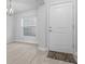 Bright entryway with a white door, modern light fixture, and stylish floor mat at 5086 Sw 91St St, Ocala, FL 34476