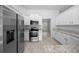 Bright kitchen features stainless steel appliances, white cabinets and granite countertops at 5086 Sw 91St St, Ocala, FL 34476