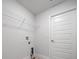 Well-equipped laundry area with overhead shelving and access door for easy management of household tasks at 5086 Sw 91St St, Ocala, FL 34476