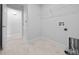 Efficient laundry room with shelving, tile flooring, and utility connections for modern convenience at 5086 Sw 91St St, Ocala, FL 34476