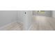 Bright living room with modern, light wood flooring and natural light streaming through a large window at 5086 Sw 91St St, Ocala, FL 34476