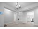 Open-concept living room with natural light, modern fixtures, and beautiful wood-look tile flooring at 5086 Sw 91St St, Ocala, FL 34476