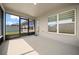 Screened patio offers a comfortable outdoor space with neutral tones and ample sunlight at 5086 Sw 91St St, Ocala, FL 34476