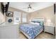 Well-lit bedroom features ceiling fan, bedside tables, and tiled floors at 5563 Nw 40Th Pl, Ocala, FL 34482
