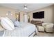 Comfortable bedroom with tile floors, ensuite bathroom, and television at 5563 Nw 40Th Pl, Ocala, FL 34482
