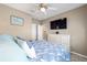 Bedroom with mounted TV and view into ensuite bathroom at 5563 Nw 40Th Pl, Ocala, FL 34482