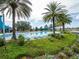 Stunning community pool surrounded by lush landscaping, palm trees, and comfortable lounge chairs at 5563 Nw 40Th Pl, Ocala, FL 34482