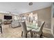 Bright dining room with tile floors, a glass table, modern lighting, and open access to living spaces at 5563 Nw 40Th Pl, Ocala, FL 34482