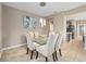 Bright dining room featuring elegant lighting, stylish chairs, and modern glass top table at 5563 Nw 40Th Pl, Ocala, FL 34482