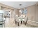 Elegant dining room with a glass table, modern chandelier, tile flooring, and seamless access to adjacent rooms at 5563 Nw 40Th Pl, Ocala, FL 34482
