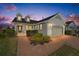 Charming home exterior with a brick driveway, manicured landscaping and inviting front porch at 5563 Nw 40Th Pl, Ocala, FL 34482