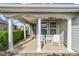 Inviting front porch featuring classic white columns and comfortable seating under a covered ceiling at 5563 Nw 40Th Pl, Ocala, FL 34482