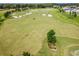 Aerial view of the sprawling golf course, featuring lush fairways and manicured greens at 5563 Nw 40Th Pl, Ocala, FL 34482