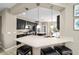 Modern kitchen with stainless steel appliances, quartz countertops, breakfast bar with seating, and stylish pendant lights at 5563 Nw 40Th Pl, Ocala, FL 34482