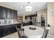Charming eat-in kitchen featuring dark wood cabinetry, tiled backsplash, stainless appliances and an adjacent laundry room at 5563 Nw 40Th Pl, Ocala, FL 34482