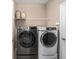 Convenient laundry room featuring a front-loading washer, dryer and wire shelving at 5563 Nw 40Th Pl, Ocala, FL 34482