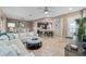 Open-concept living room with stylish furnishings, tile flooring, adjacent dining area, and seamless kitchen access at 5563 Nw 40Th Pl, Ocala, FL 34482