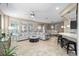 Open-concept living room with tile flooring, modern furnishings, and abundant natural light at 5563 Nw 40Th Pl, Ocala, FL 34482