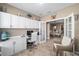 Well-lit home office with custom built-in shelving, desk, and view of the dining area at 5563 Nw 40Th Pl, Ocala, FL 34482