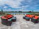 Relaxing outdoor seating area with comfortable seating arrangements and a picturesque lake backdrop at 5563 Nw 40Th Pl, Ocala, FL 34482