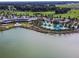 A picturesque aerial view of the community pool area next to a lake, surrounded by palm trees at 5563 Nw 40Th Pl, Ocala, FL 34482