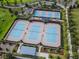 Aerial shot of a neighborhood tennis court showcasing well maintained grounds and lush landscaping at 5563 Nw 40Th Pl, Ocala, FL 34482
